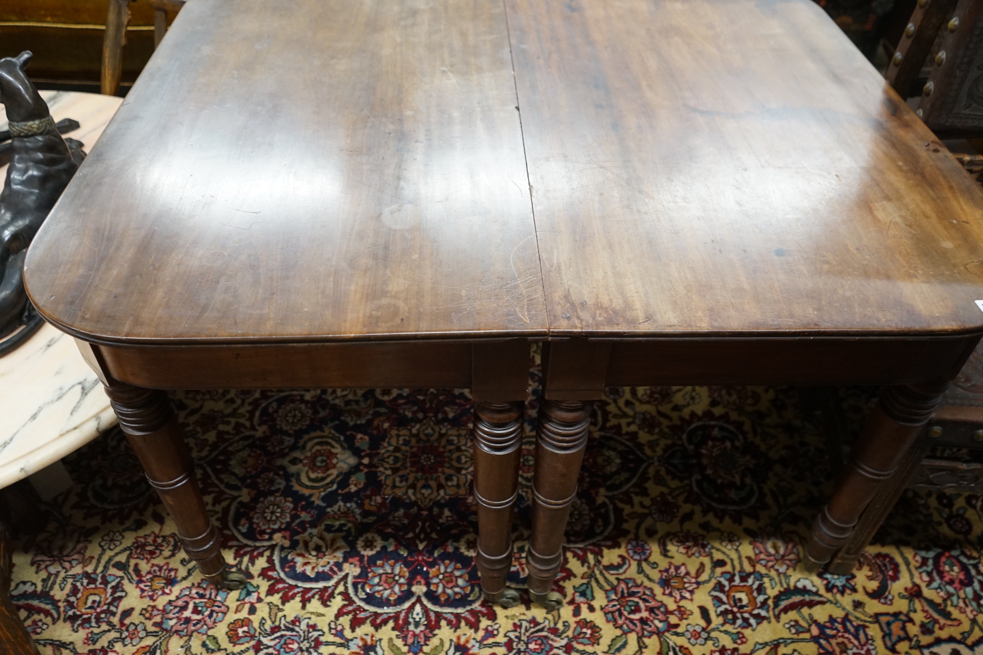 A pair of Regency mahogany table D end sections, length 128cm, depth 112cm, height 72cm